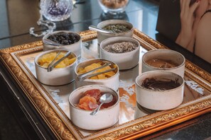 A tray with various food items including fruits and nuts. - Hotel Muse Bangkok, Autograph Collection (Bangkok)