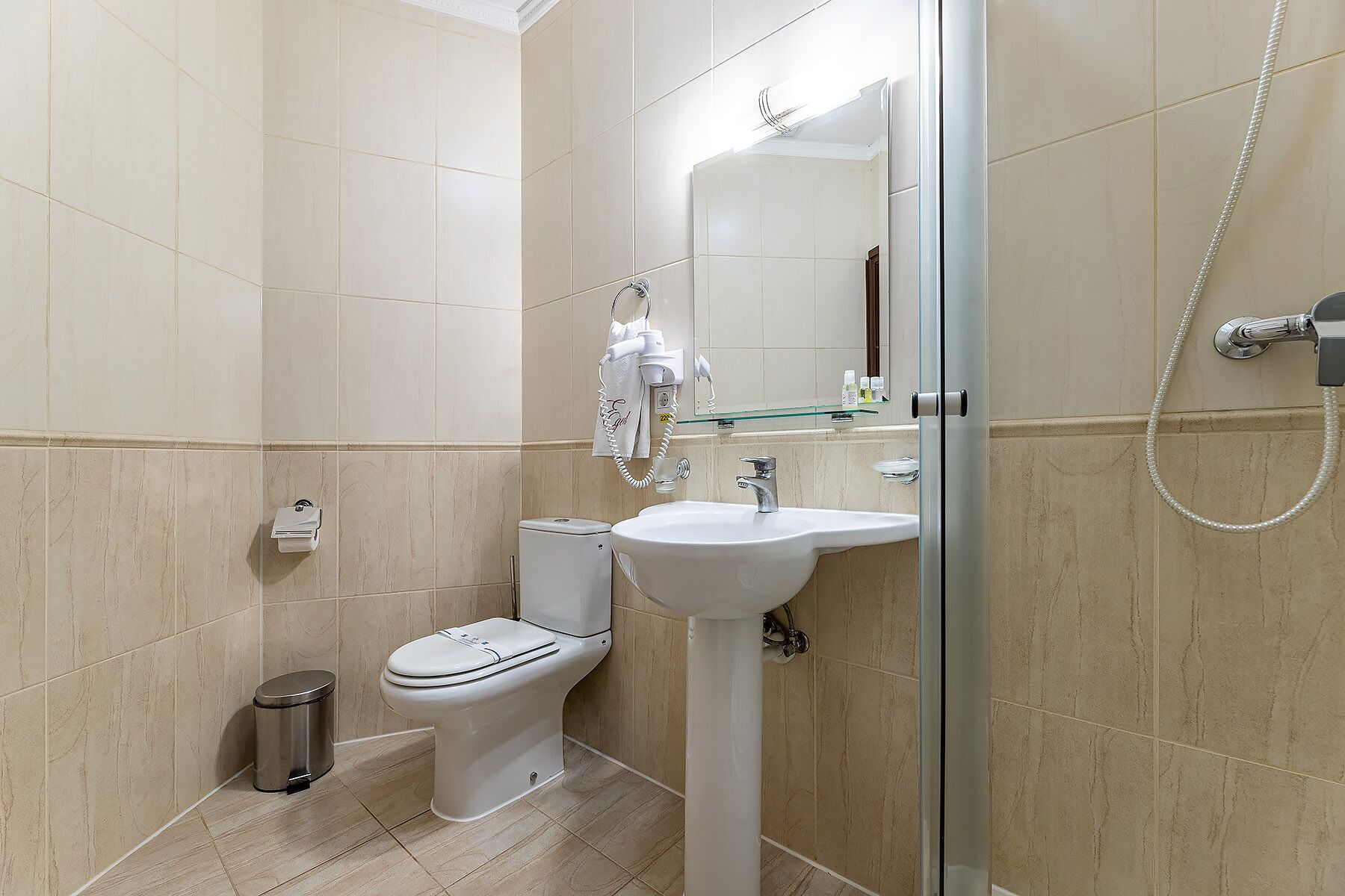 A modern bathroom with a toilet, sink, and shower.