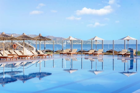 Seasonal outdoor pool, open 8:00 AM to 7:00 PM, pool umbrellas