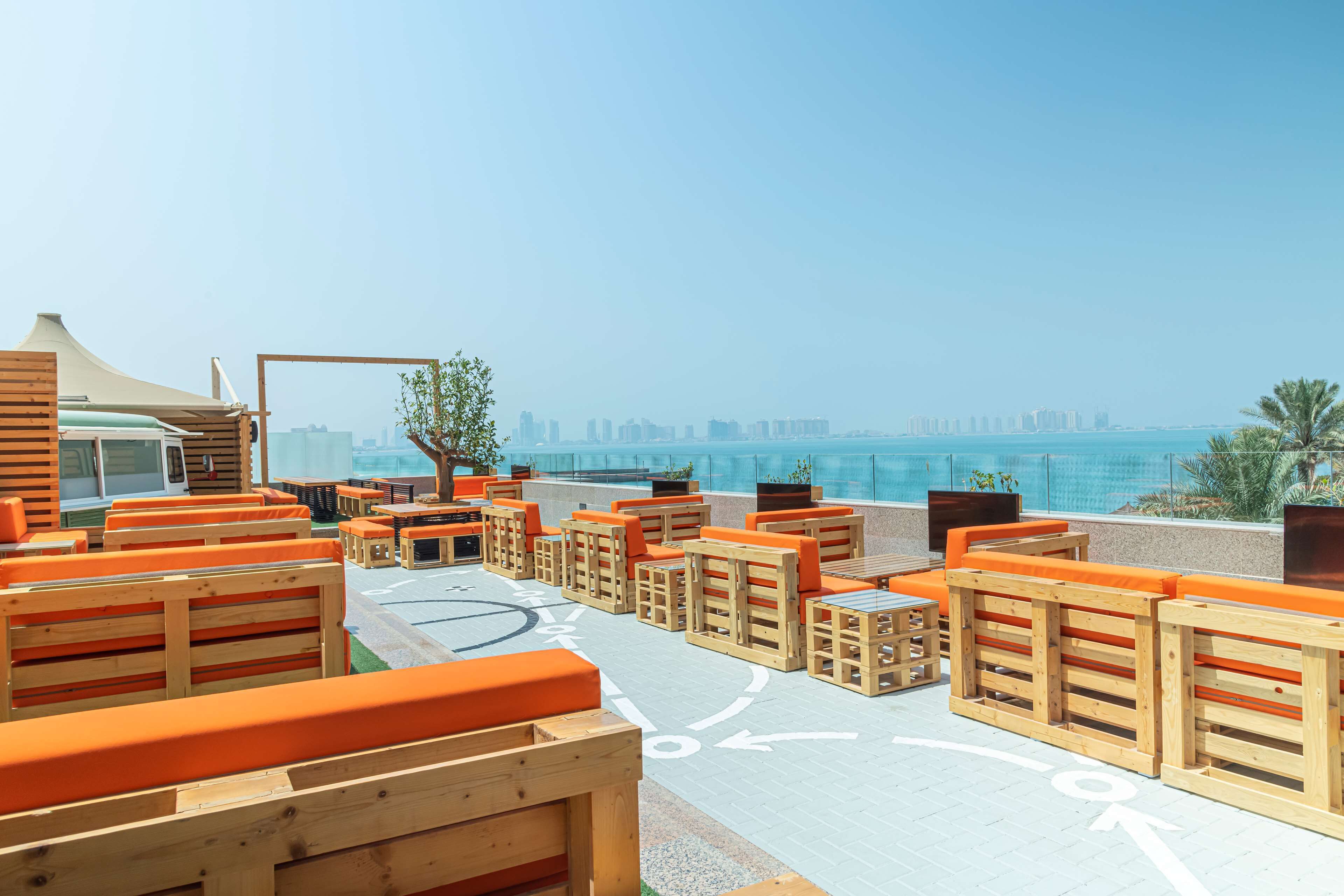 Outdoor seating with a view of the city skyline.