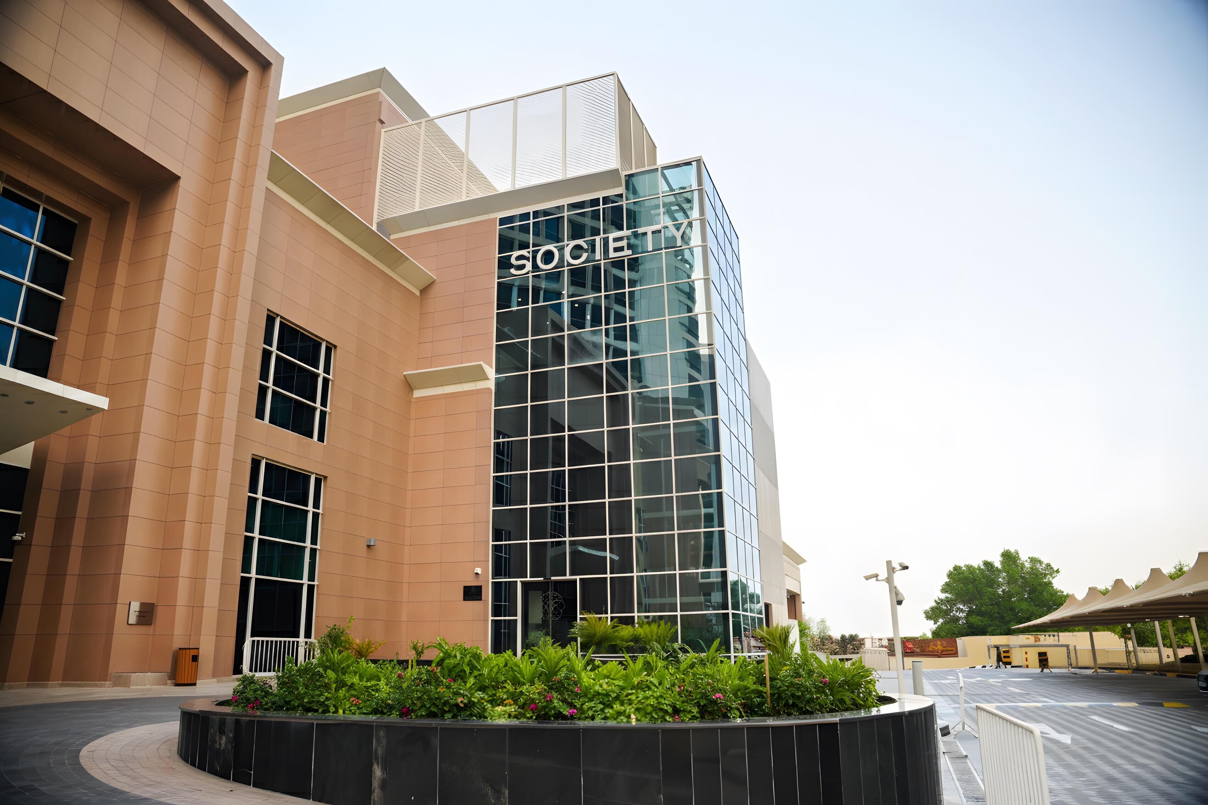 A modern building with a glass facade and the word "SOCIETY" on the side.