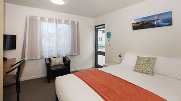 Desk, laptop workspace, blackout drapes, iron/ironing board