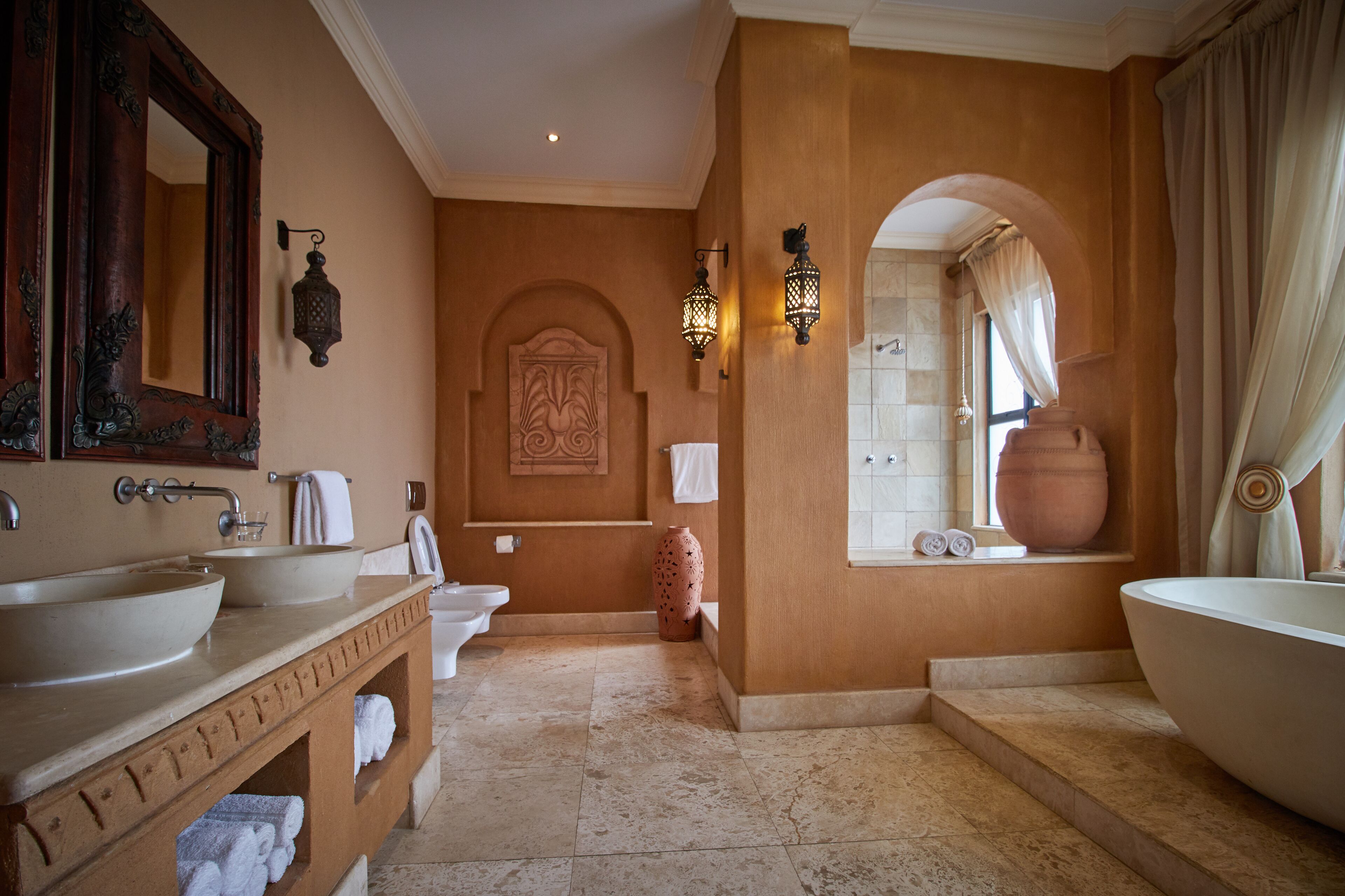 Une salle de bain avec deux lavabos, une baignoire et des toilettes.
