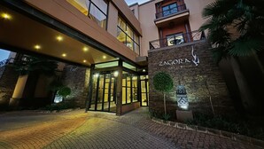 A modern building with a sign reading "Zagora Grill Room" at the entrance. - Tayfin Royale Hotel & Restaurant (Centurion)