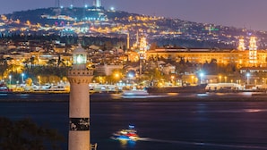 A cityscape at night with a prominent tower and a lighthouse. - Tria Elegance Istanbul (Istanbul)