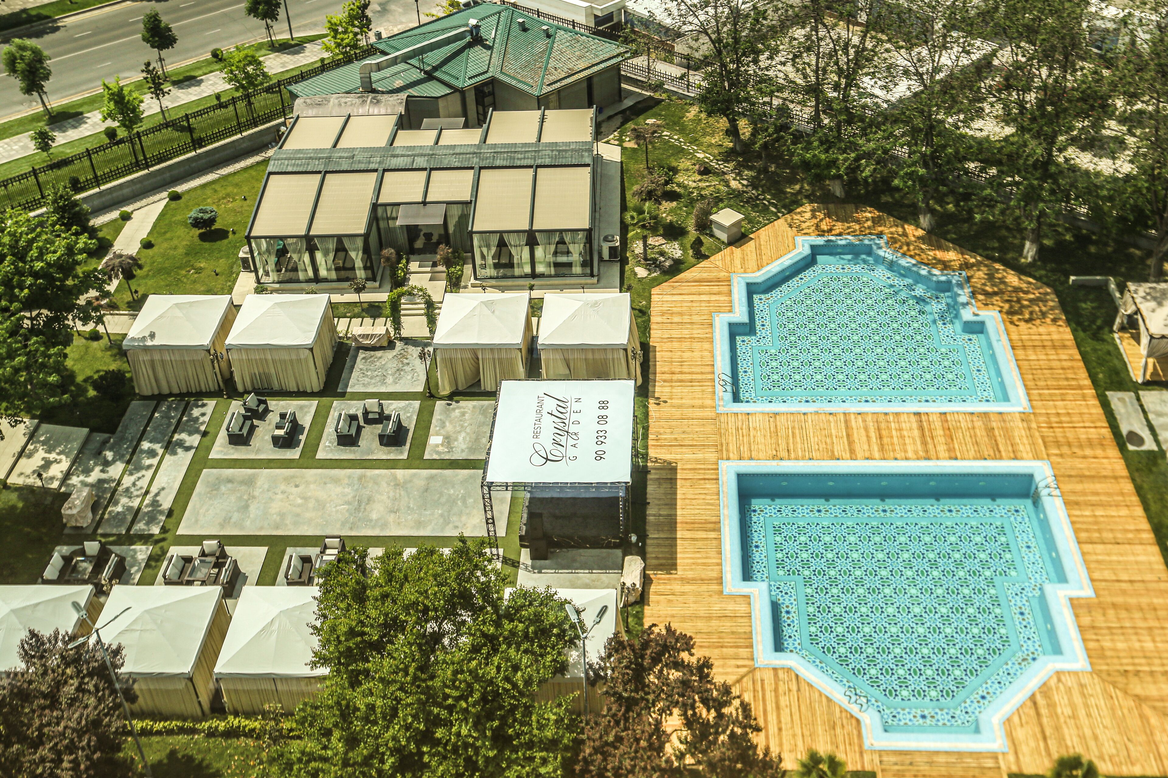 A hotel with a rooftop pool, outdoor seating, and a restaurant.
