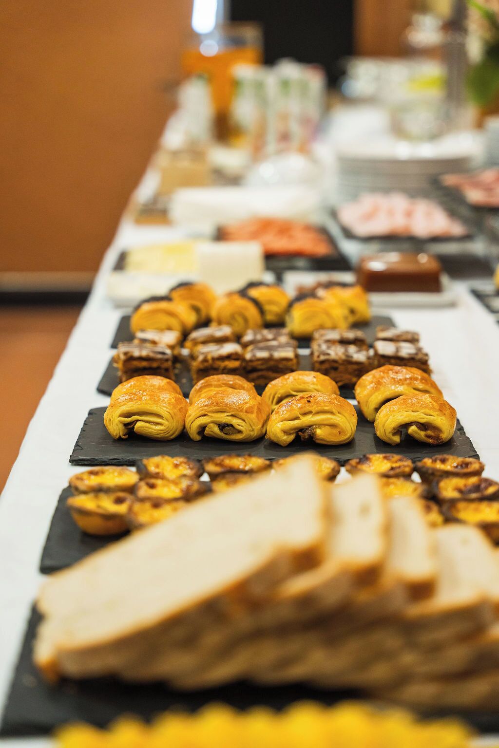 A buffet with various pastries and desserts.