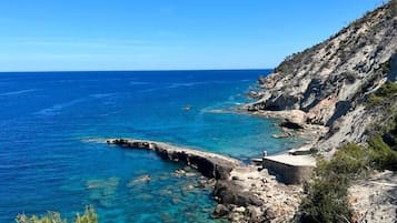 Beach nearby, black sand, beach umbrellas, beach towels