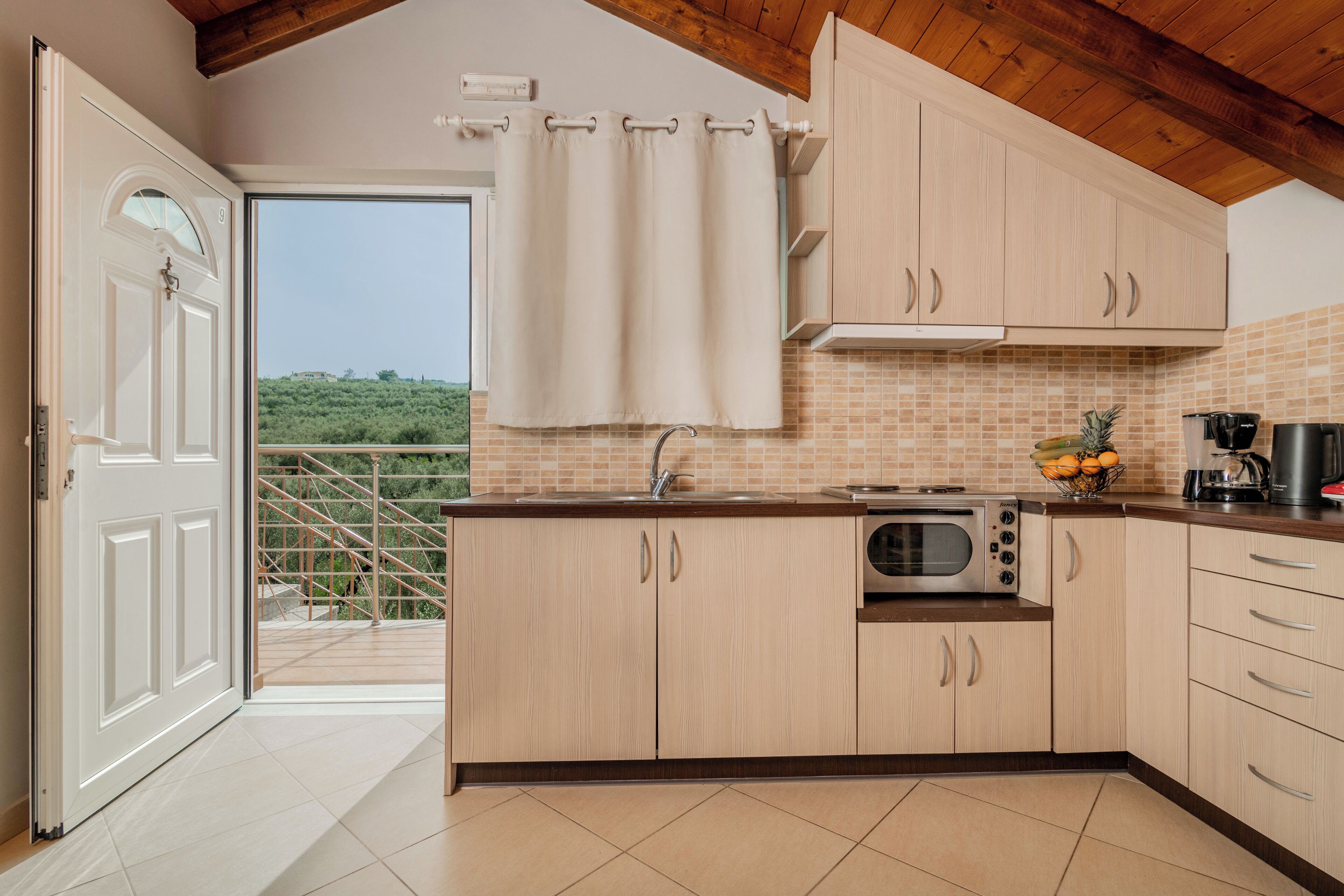 A kitchen with wooden cabinets, a microwave, and a coffee maker.
