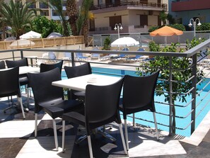 Seasonal outdoor pool, open 9:00 AM to 8:00 PM, pool umbrellas
