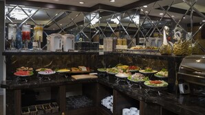 A buffet setup with various food items and a coffee station. - Splendid Star Grand Hotel & Spa (Hanoi)
