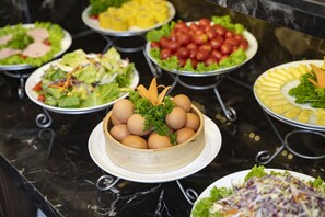 A buffet table with various dishes including salads, pasta, and a central display of eggs. - Splendid Star Grand Hotel & Spa (Hanoi)