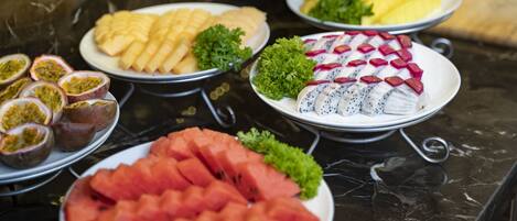 A variety of fruits and vegetables arranged on a marble table.