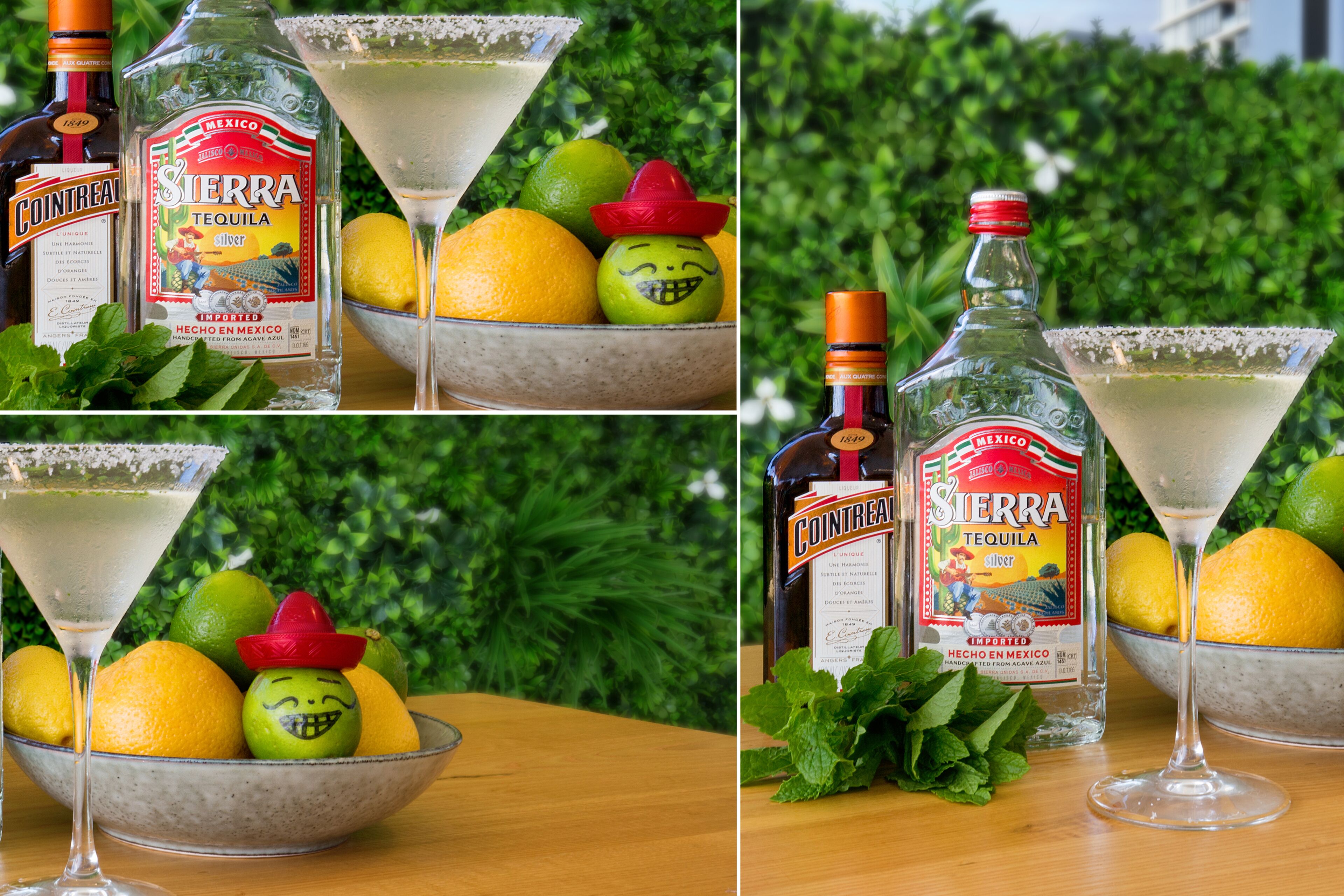 A table with a bottle of Sierra tequila, a glass of tequila, lemons, and a bowl of fruit with a sombrero.