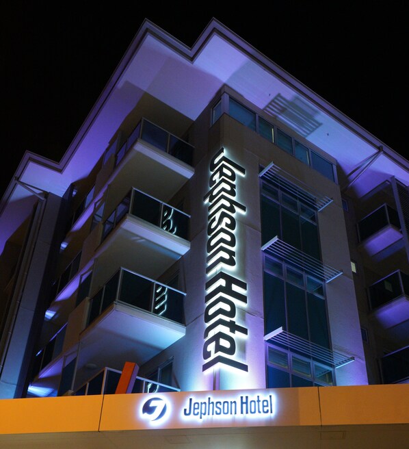 A Jephson Hotel building with illuminated signage, multiple balconies, and a modern architectural design. - Jephson Hotel & Apartments (Toowong)