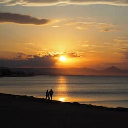 On the beach, white sand, sun loungers, beach towels