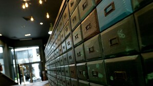 A row of metal filing cabinets in a hallway.