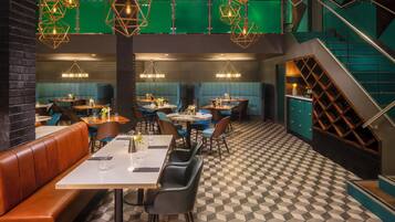 A restaurant with booths, tables, and a checkered floor.