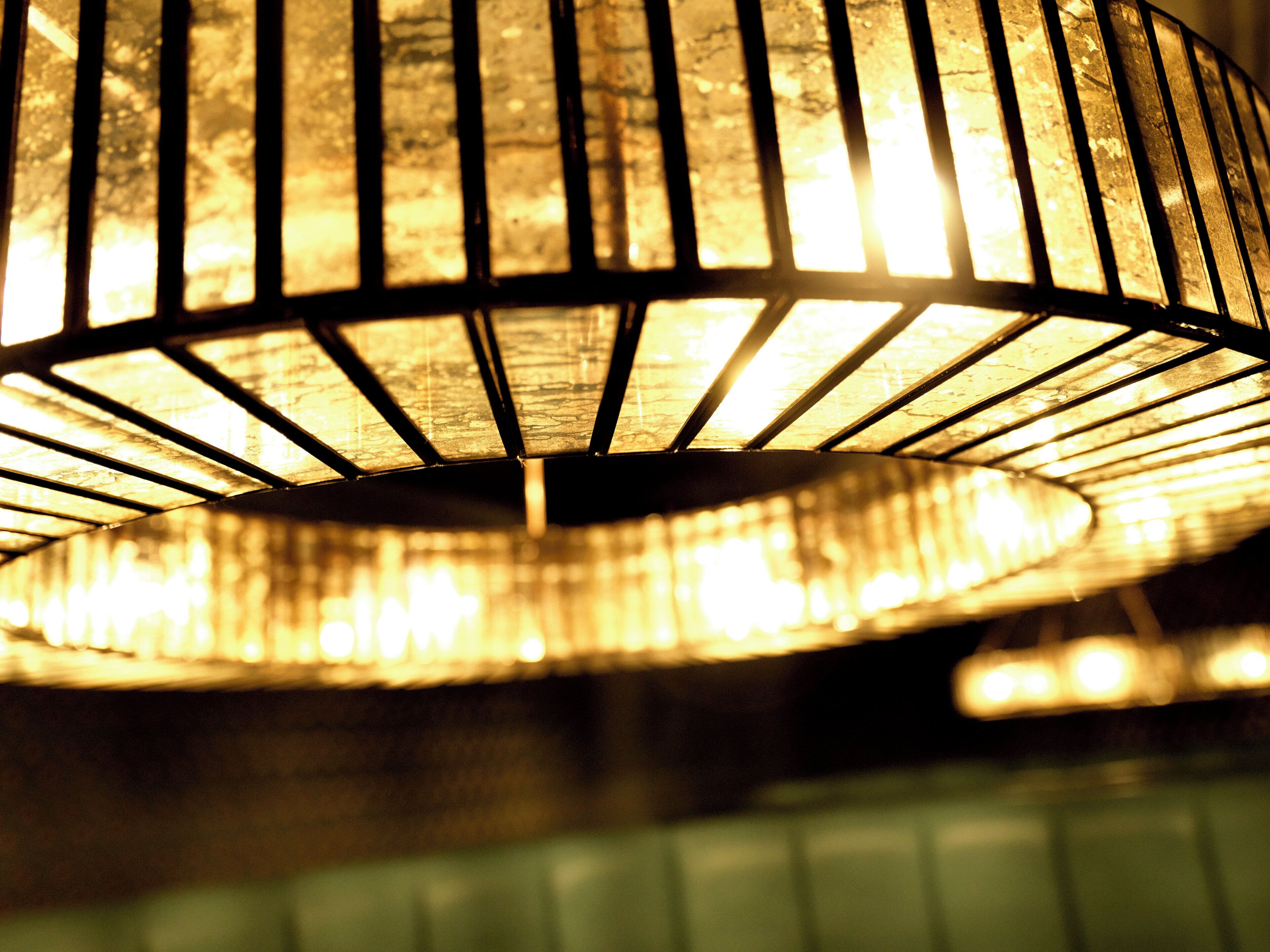 A close-up of a circular, ribbed light fixture with a warm glow.