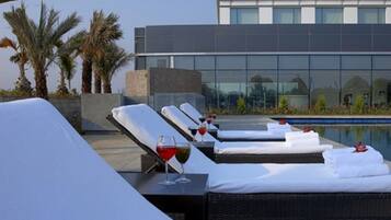 Outdoor pool, open 7:00 AM to 9:00 PM, pool umbrellas, pool loungers