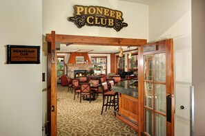 A Pioneer Club with a membership sign, a bar area, and a fireplace. - Water House on Main Street (Breckenridge)