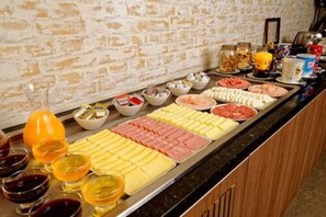 A buffet with various food items and condiments.