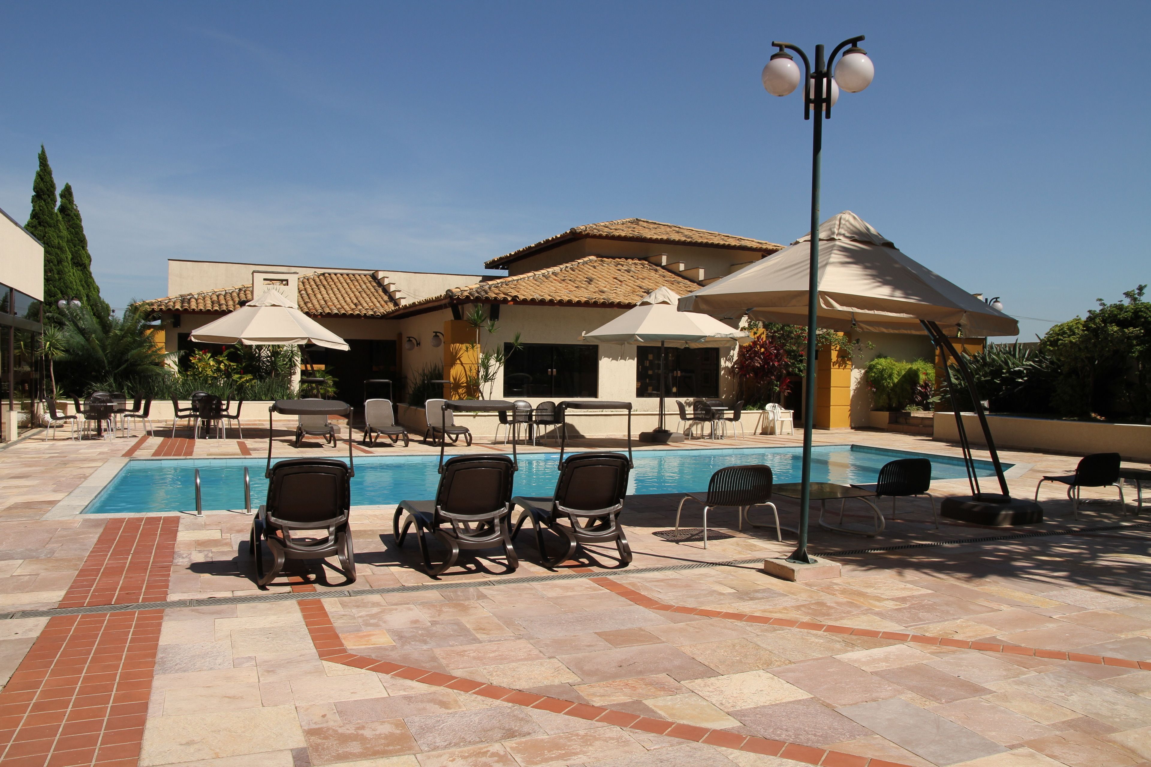 outdoor pool, open 7:00 am to 9:00 pm, pool umbrellas, pool loungers