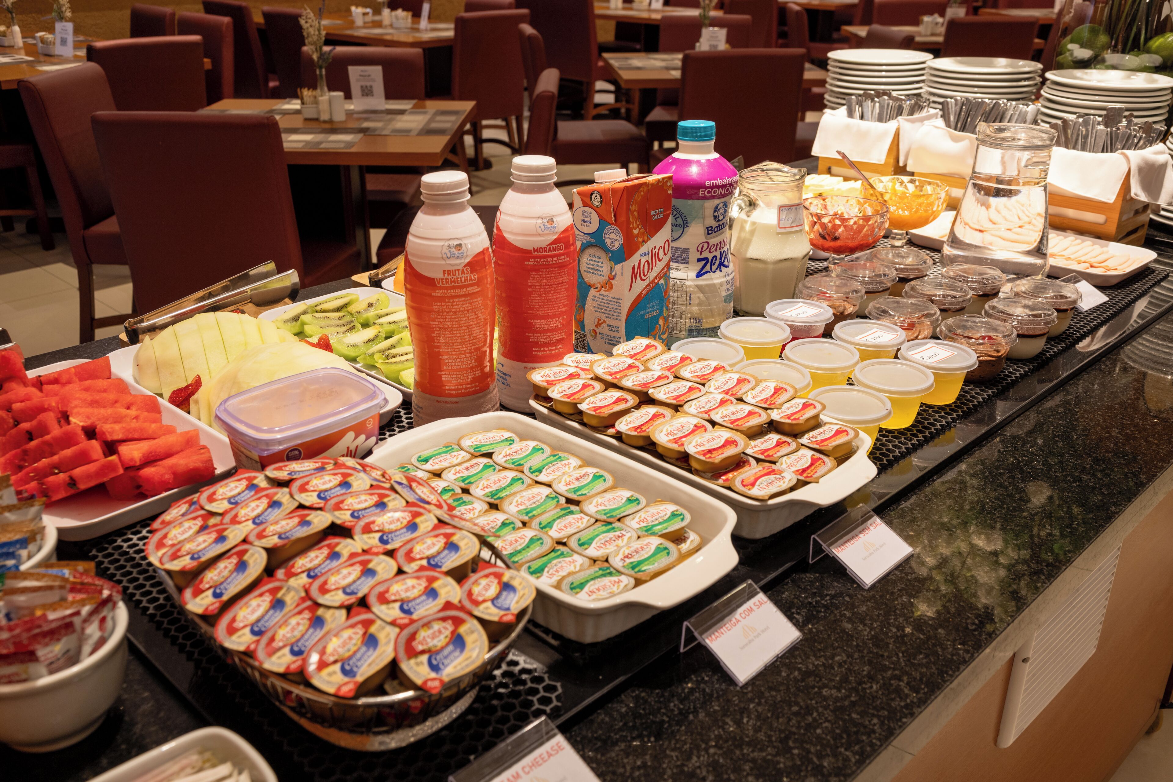 A buffet with various food items and beverages.