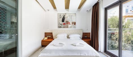 A modern bedroom with a large bed, a glass shower enclosure, a ceiling with exposed beams, and a city view through large windows.