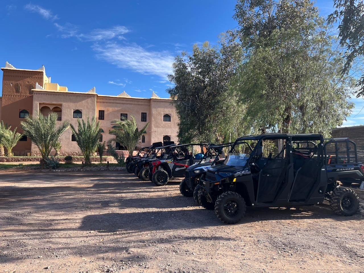 A row of ATVs parked in front of a building with a desert landscape.