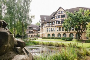 A traditional European-style building with a courtyard, stone pathway, and a pond. - Rabenstein (Raben Steinfeld)