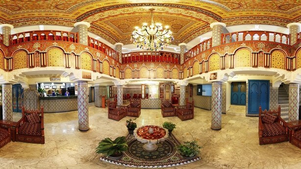 A grand lobby with ornate columns, a reception desk, and a central seating area with a fountain. - Moroccan House Hotel Casablanca (Casablanca)