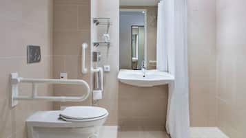 Ein modernes Badezimmer mit Toilette, Waschbecken und Dusche.