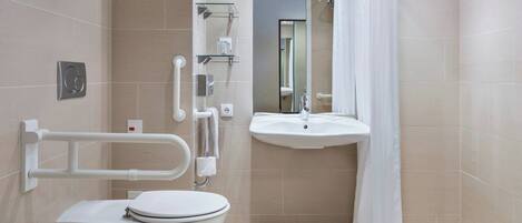 A modern bathroom with a toilet, sink, and shower.