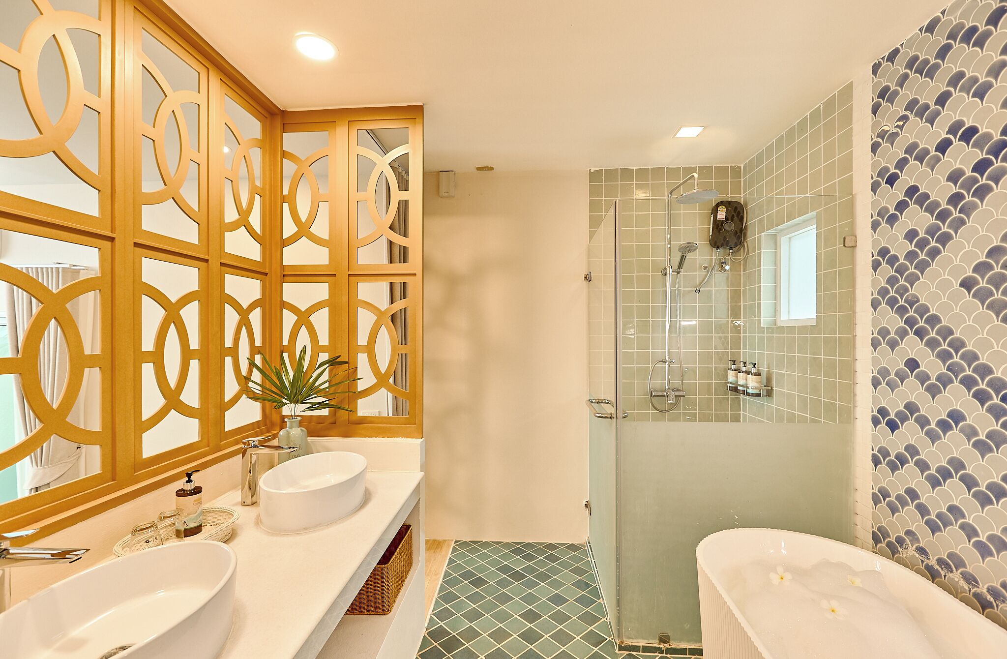 A bathroom with a large white bathtub, a separate shower area, and a vanity with two sinks.