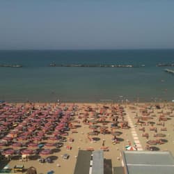 On the beach, white sand, sun-loungers, beach umbrellas