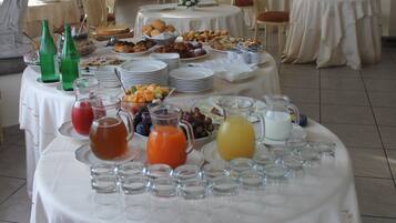 A breakfast buffet with various food items and beverages.
