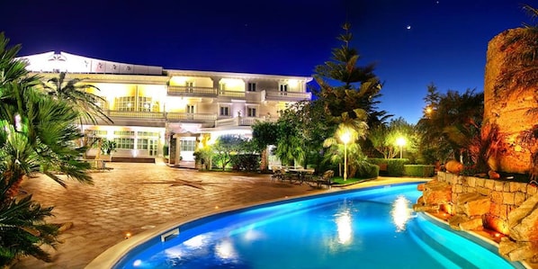 Una piscina al aire libre, sombrillas