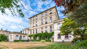 A large, historic building with multiple windows and a well-maintained lawn in front. - The Ayrlington (Bath)