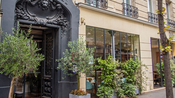 The exterior of the Grand Hotel with ornate architectural details, large windows, and a well-maintained entrance. - Grand Hotel Clichy (Clichy)
