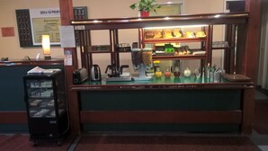 A small cafe area with a coffee machine, a toaster, and a refrigerator with beverages. - Hotel Quick Palace - Bourg Les Valence (Bourg-les-Valence)