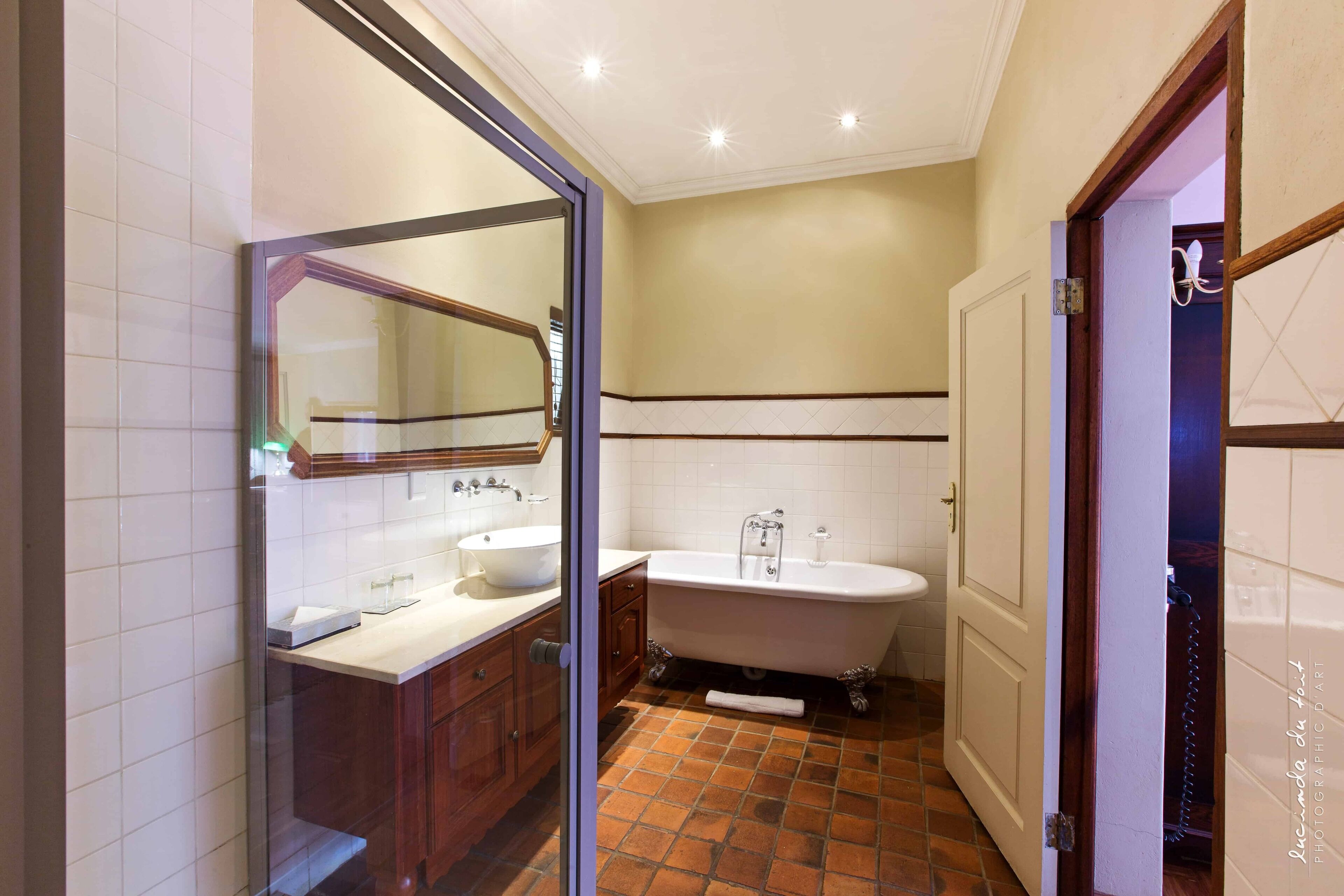 separate bathtub and shower, deep-soaking bathtub, designer toiletries