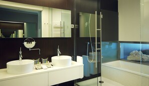 A modern bathroom with two sinks, a mirror, and a glass-enclosed shower. - Sercotel El Encin Golf (Alcala de Henares)