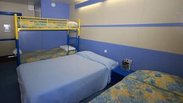 A bunk bed room with blue walls and a bunk bed with a yellow frame. There is a small table with a magazine on it.
