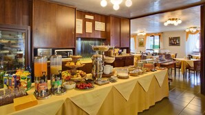 Um buffet de café da manhã com diversas opções de comidas e bebidas.