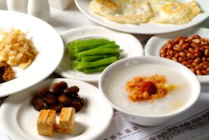 A variety of dishes including rice, tofu, and vegetables on a table. - Hotel King's Town (Kaohsiung)
