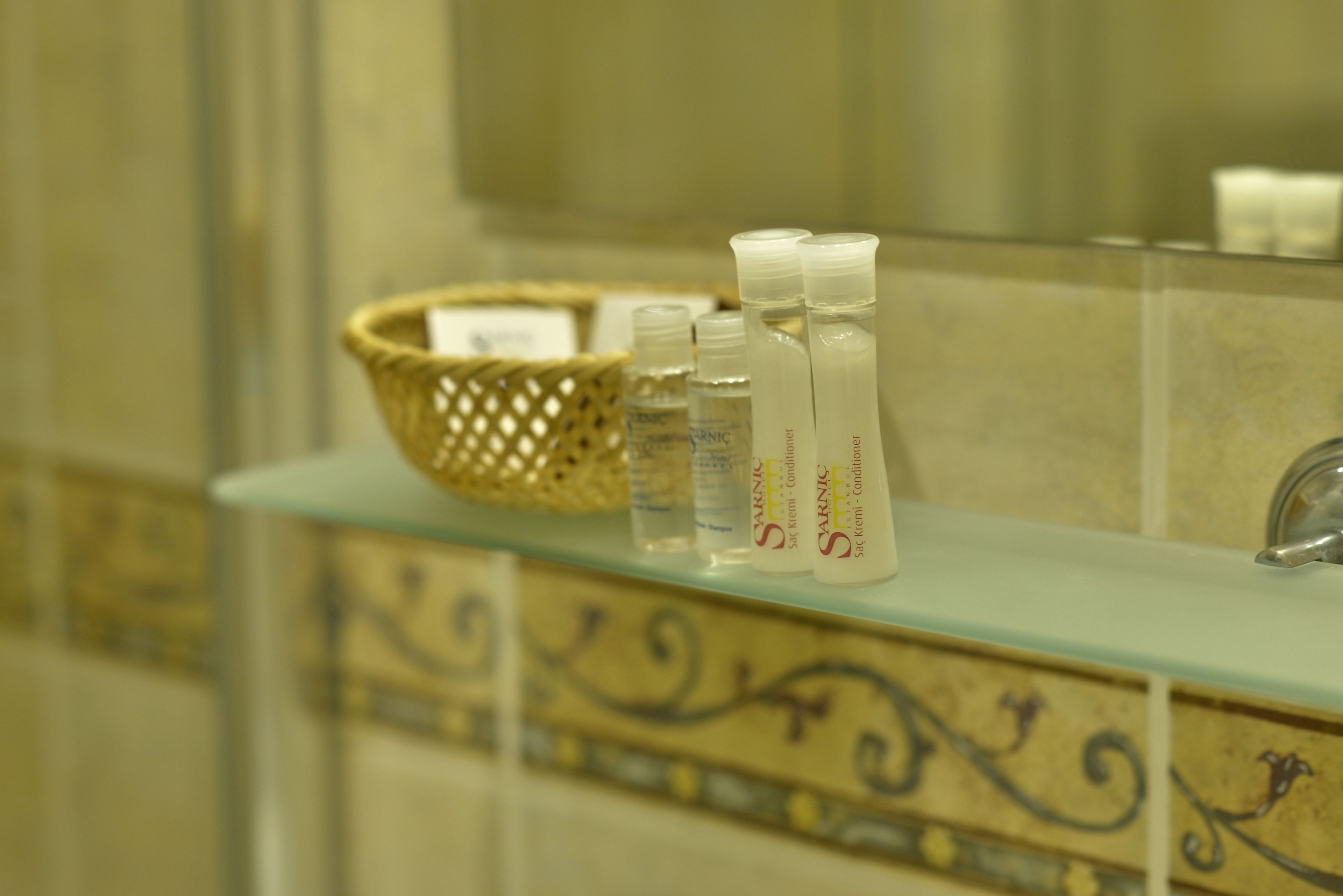 A bathroom shelf with toiletries and a woven basket.