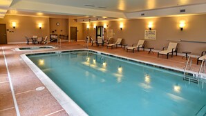 An indoor swimming pool with multiple lanes, lounge chairs, and a sign indicating no lifeguard on duty. - Hampton Inn Geneseo (Geneseo)