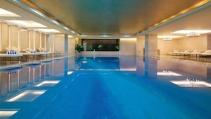 A large indoor swimming pool with lounge areas on both sides, a clear ceiling, and chandeliers. - Sheraton Xi'an North City Hotel (Xi'an)