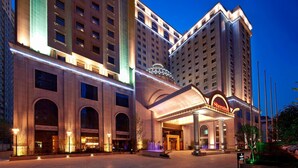 A Sheraton hotel with a grand entrance, large arched windows, and a well-lit facade. - Sheraton Xi'an North City Hotel (Xi'an)